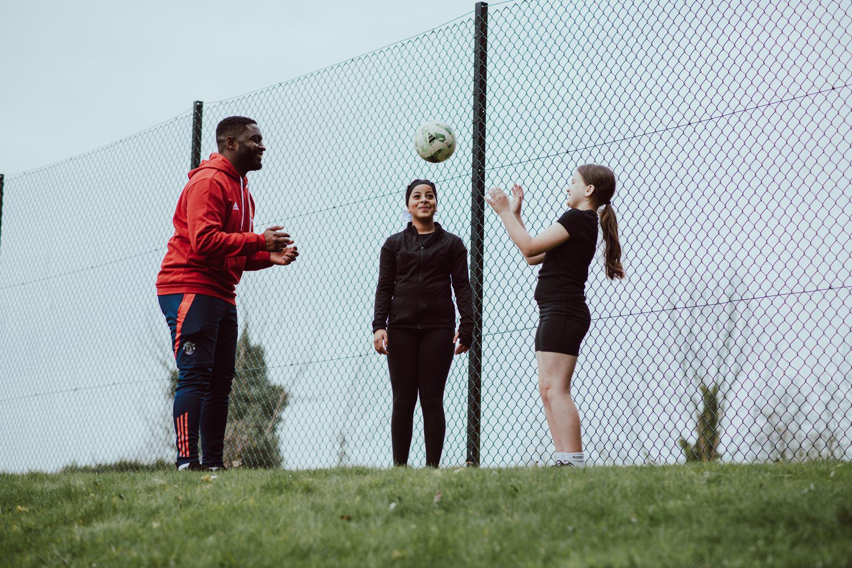 Foundation - generic image of coach and female participants playing football at The Cliff