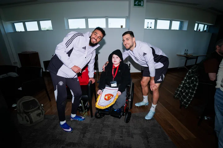 Image: Mazraoui and Dalot with a fan at Dream Day