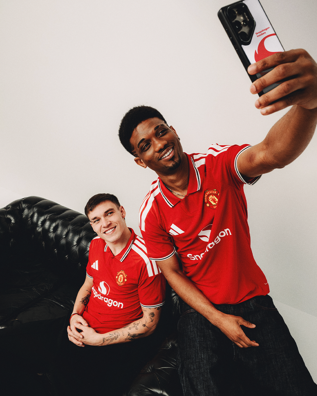 Image of Manuel Ugarte and Amad taking selfie in United 2026 27 home kit