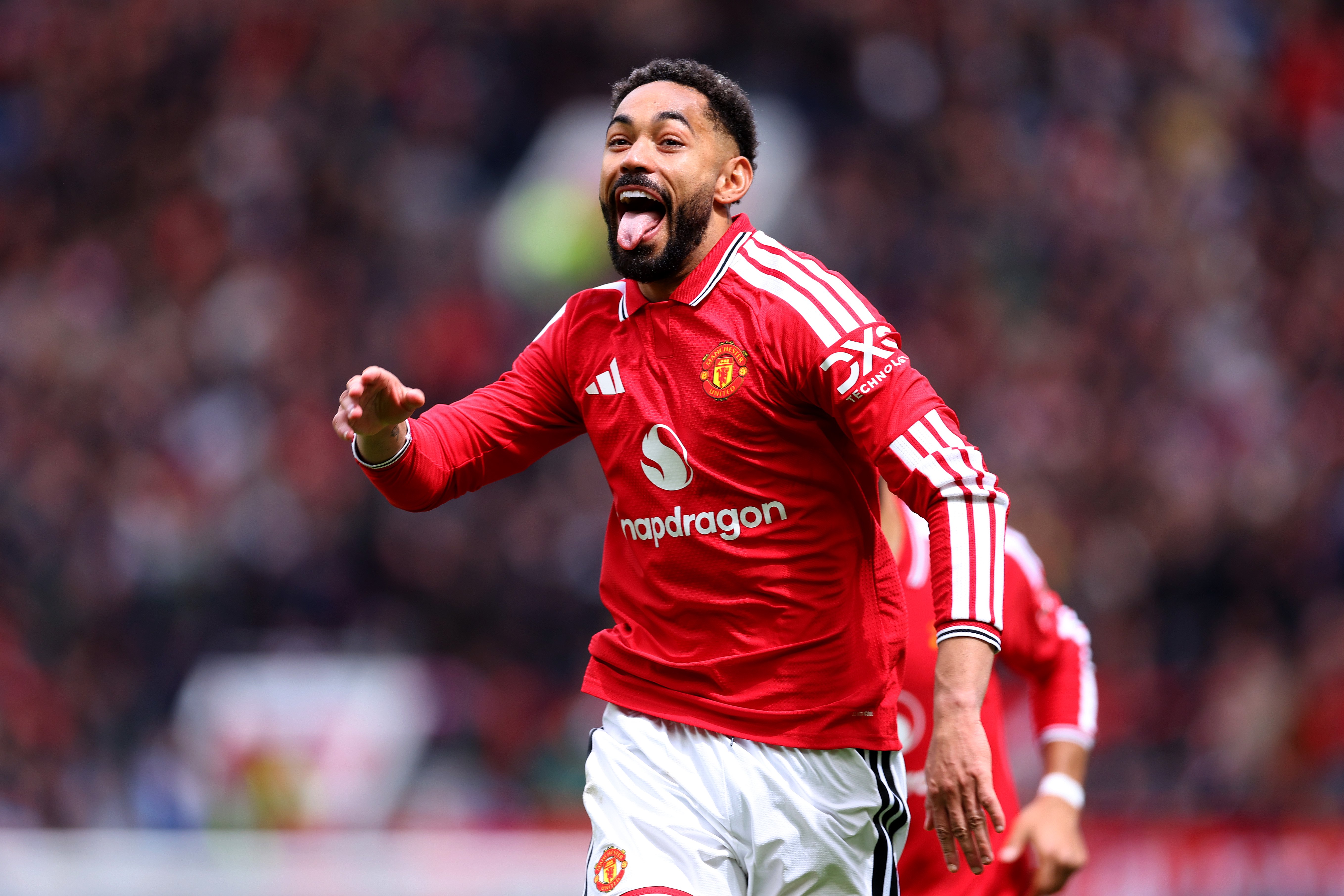 Matheus Cunha celebrating a goal with his tongue out