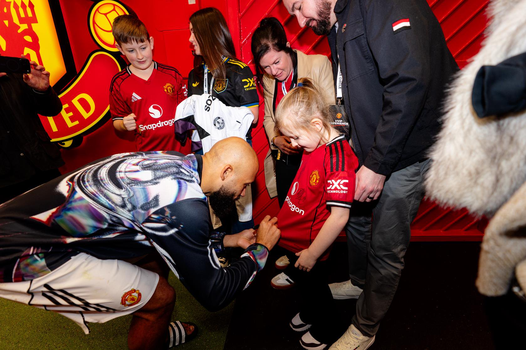 Bryan Mbeumo signing shirts in the tunnel