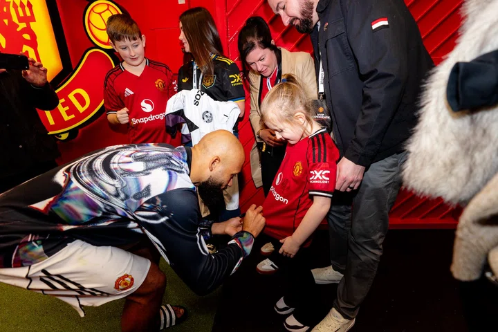 Bryan Mbeumo signing shirts in the tunnel