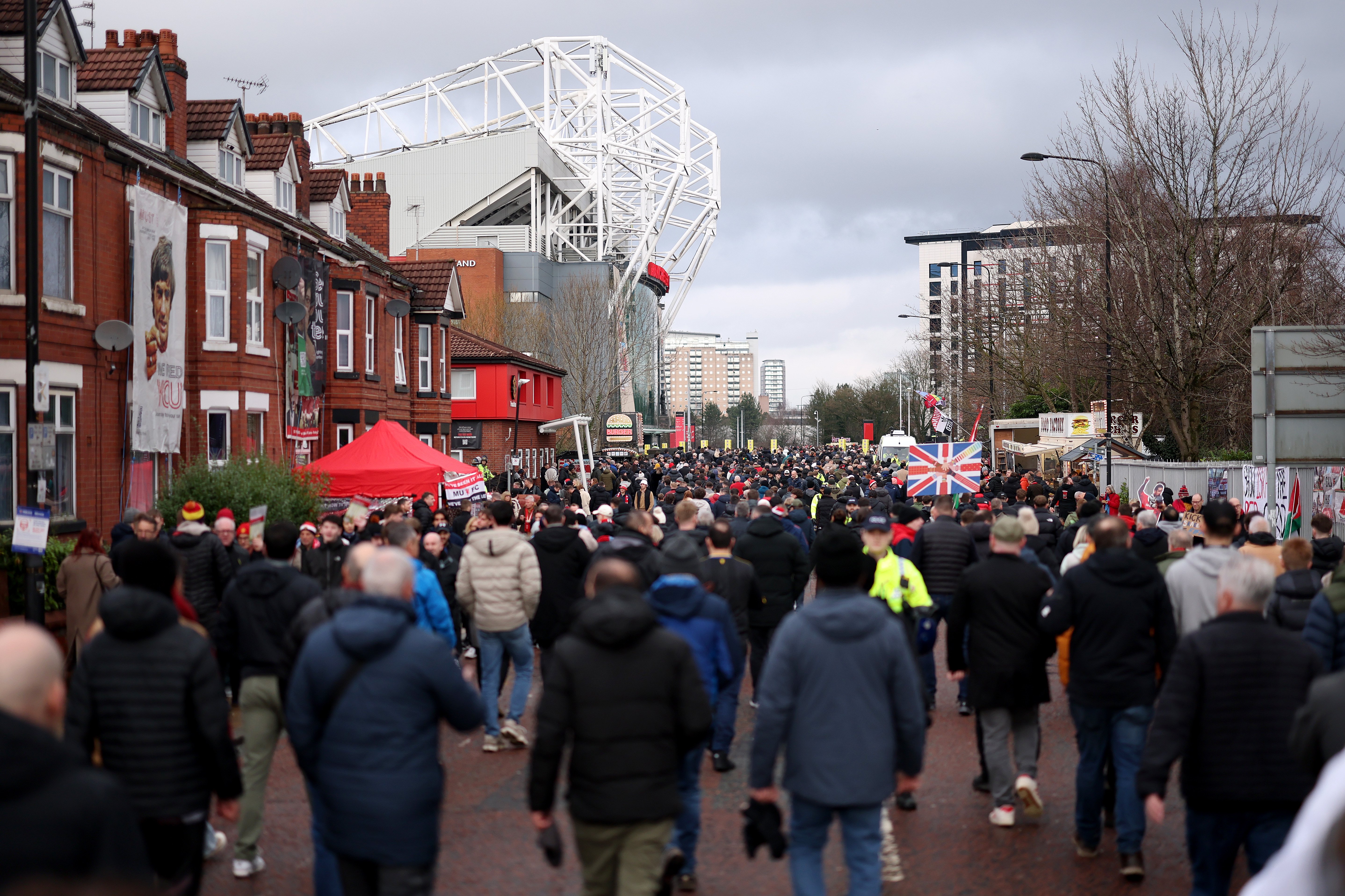 Fans walking to Old Trafford down Sir Matt Busby Way
