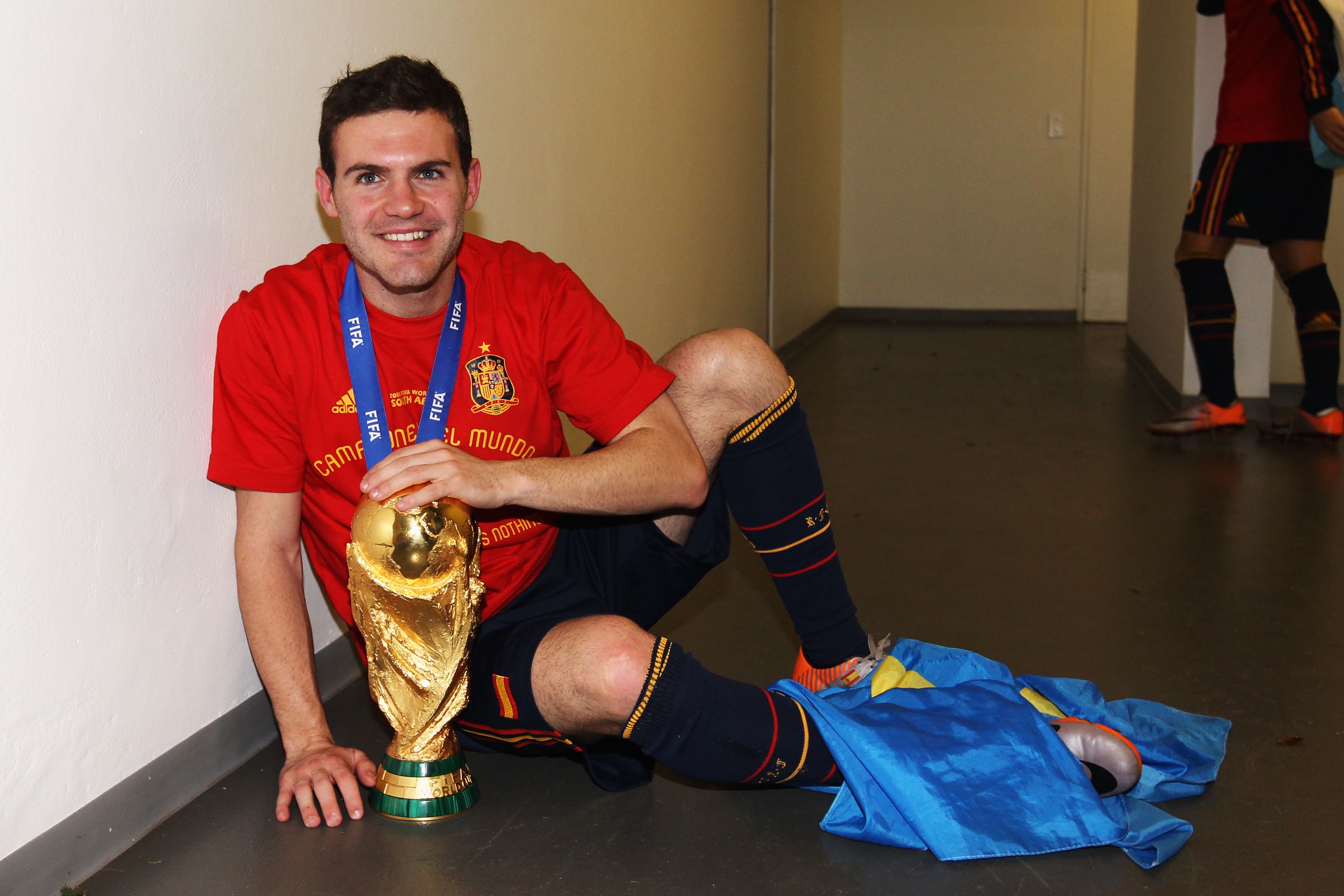 Juan Mata pictured with the World Cup and his medal after Spain win in 2010