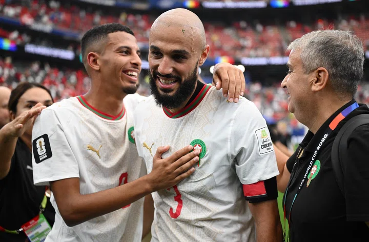 Image of Noussair Mazraoui being embraced after Morocco last 16 win at 2026 World Cup