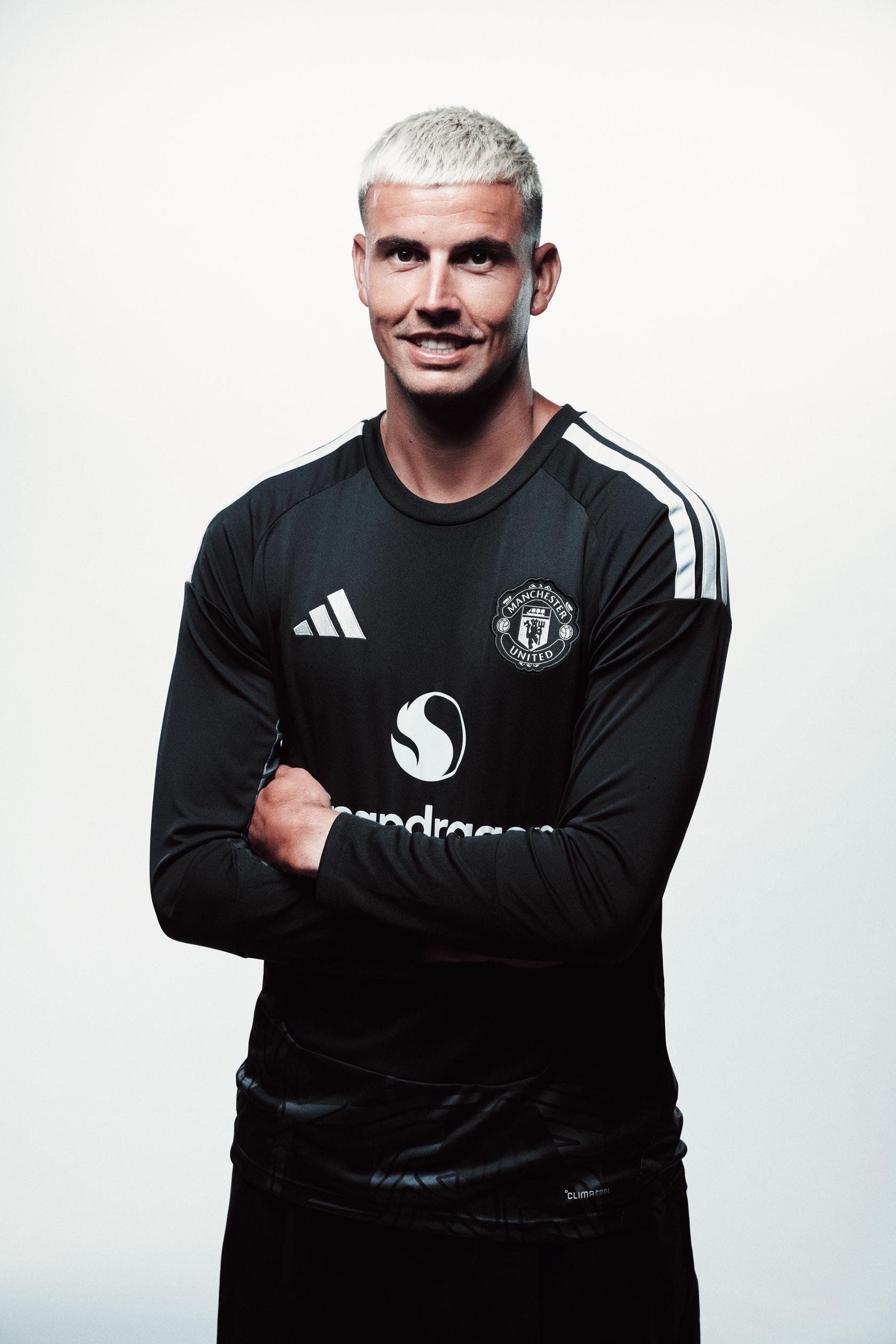 Karl Darlow smiling with arms folded in black goalkeeper kit