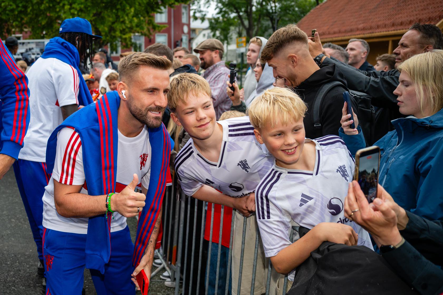 Luke Shaw with fans as he arrives at hotel in Trondheim