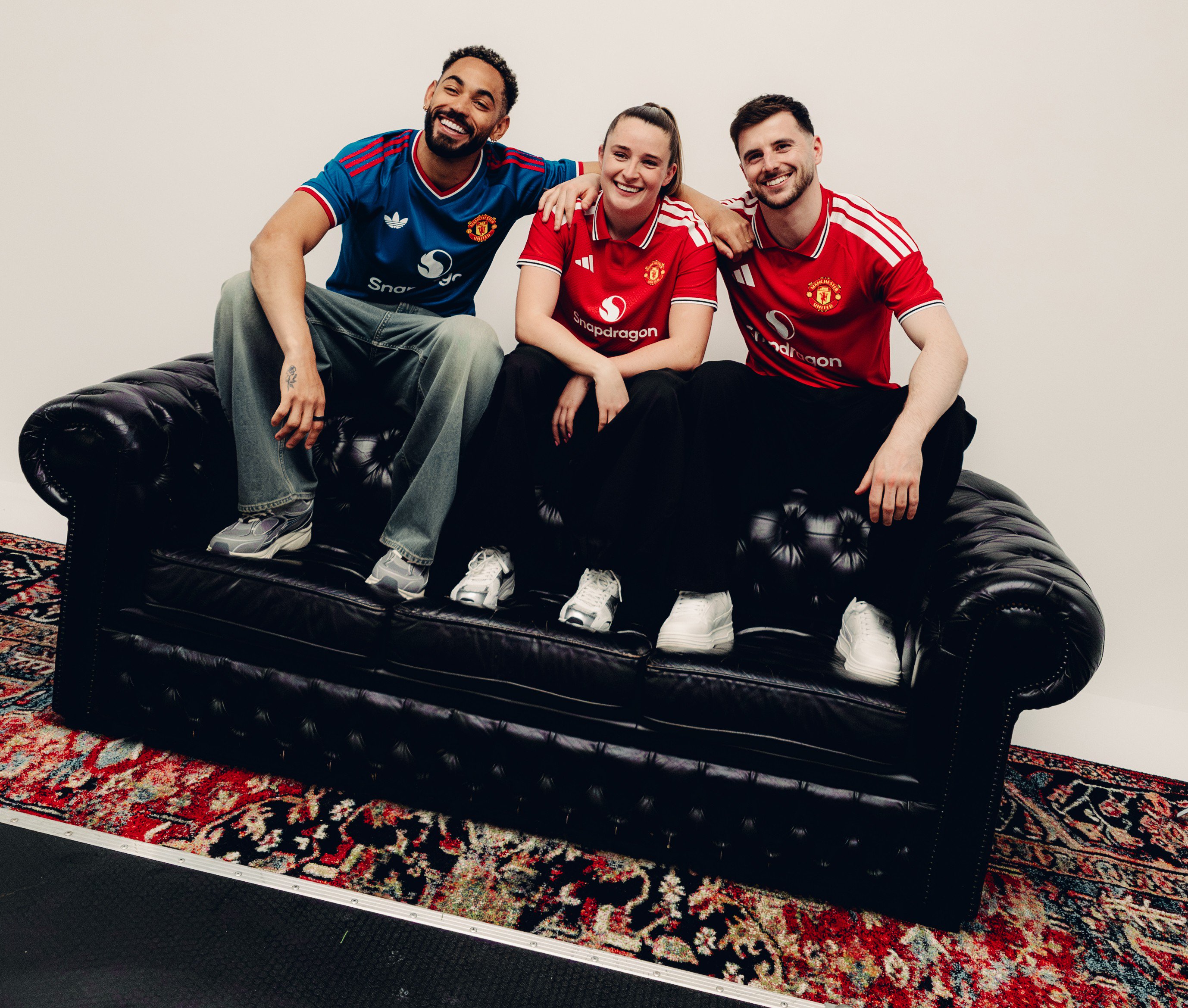 Cunha, Toone and Mount on sofa at kit launch 2026/27