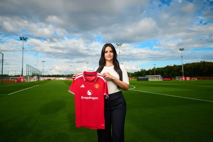 Eva Olid holds Man Utd shirt at Carrington outside