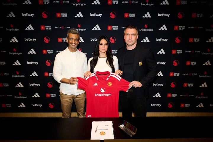 Eva Olid holding up Manchester United shirt