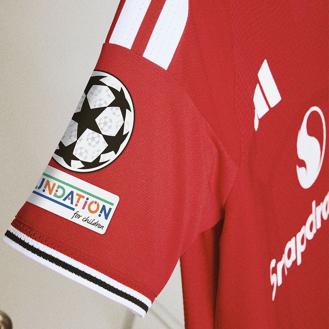 Champions League badge on home kit