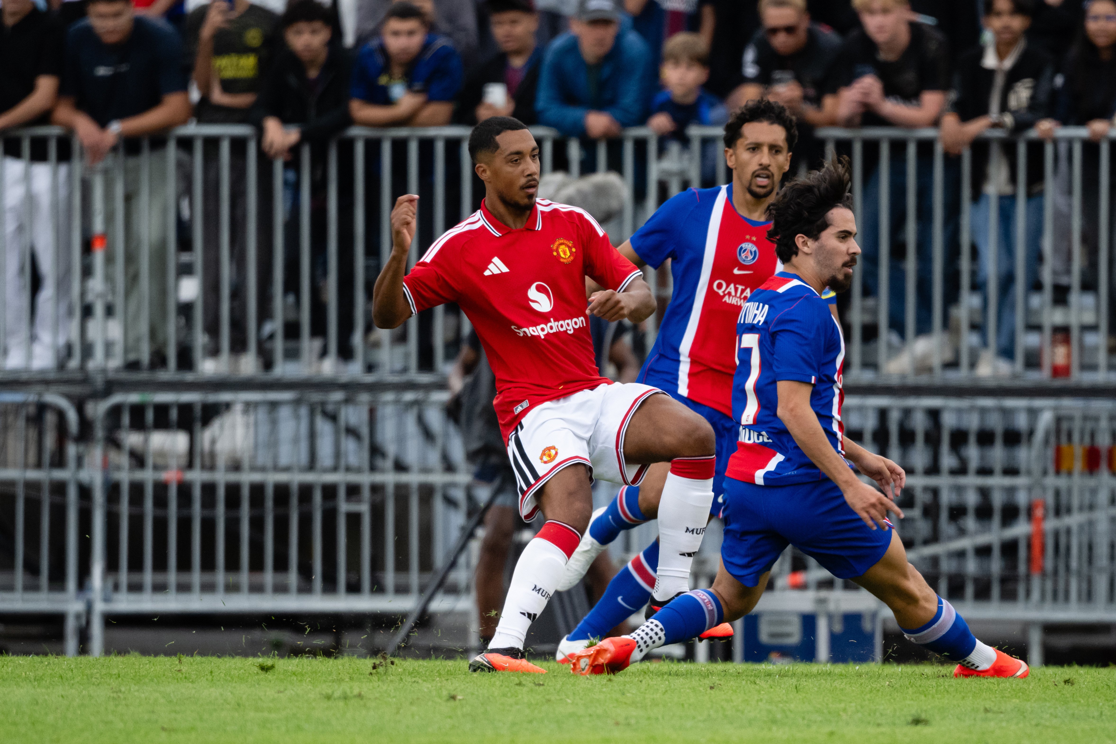 Youri Tielemans passing ball beyond Vitinha in PSG clash