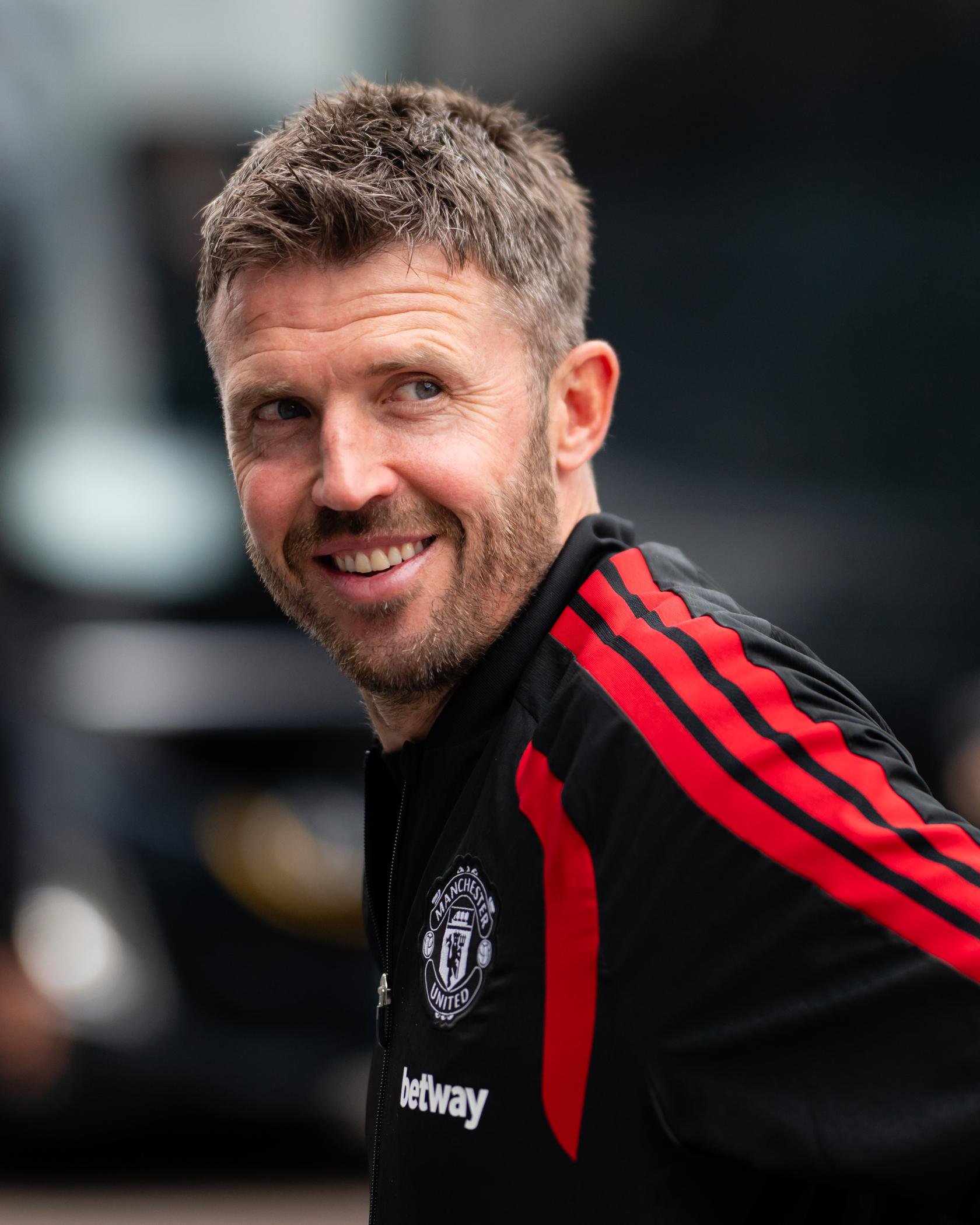 Michael Carrick smiling in black top