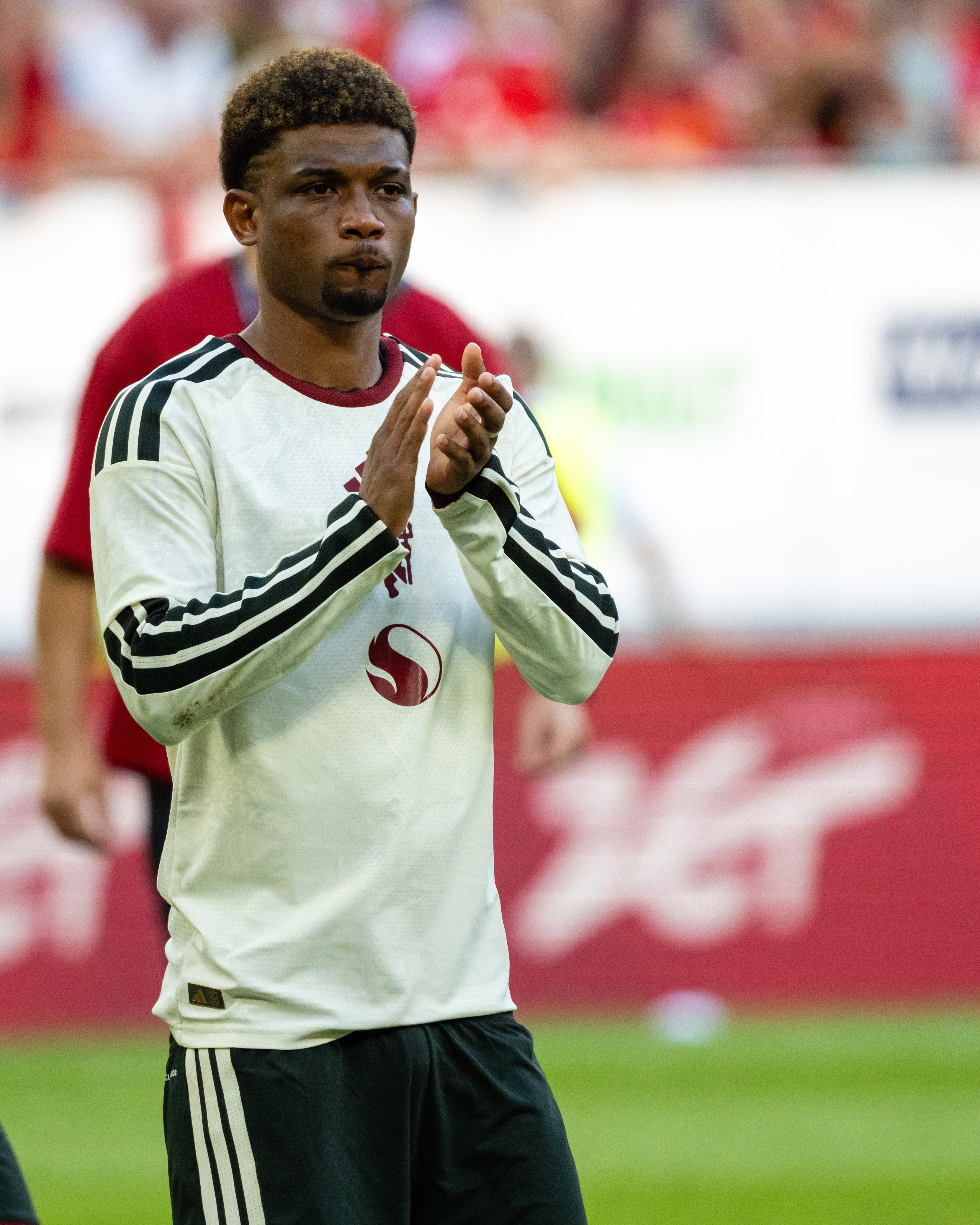 Amad claps in white shirt in Poland