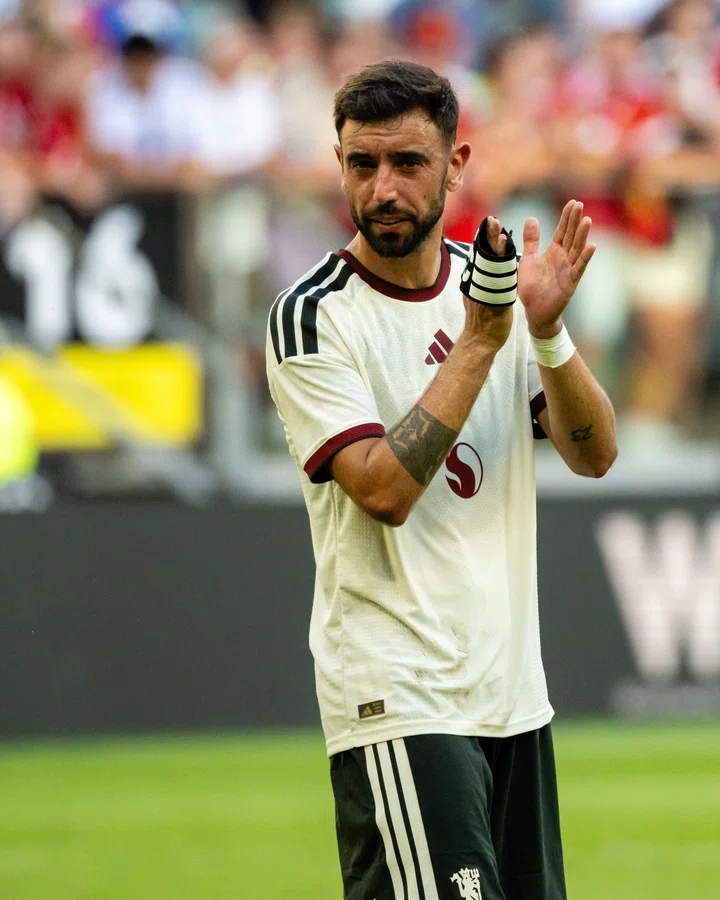 Bruno Fernandes clapping in white shirt