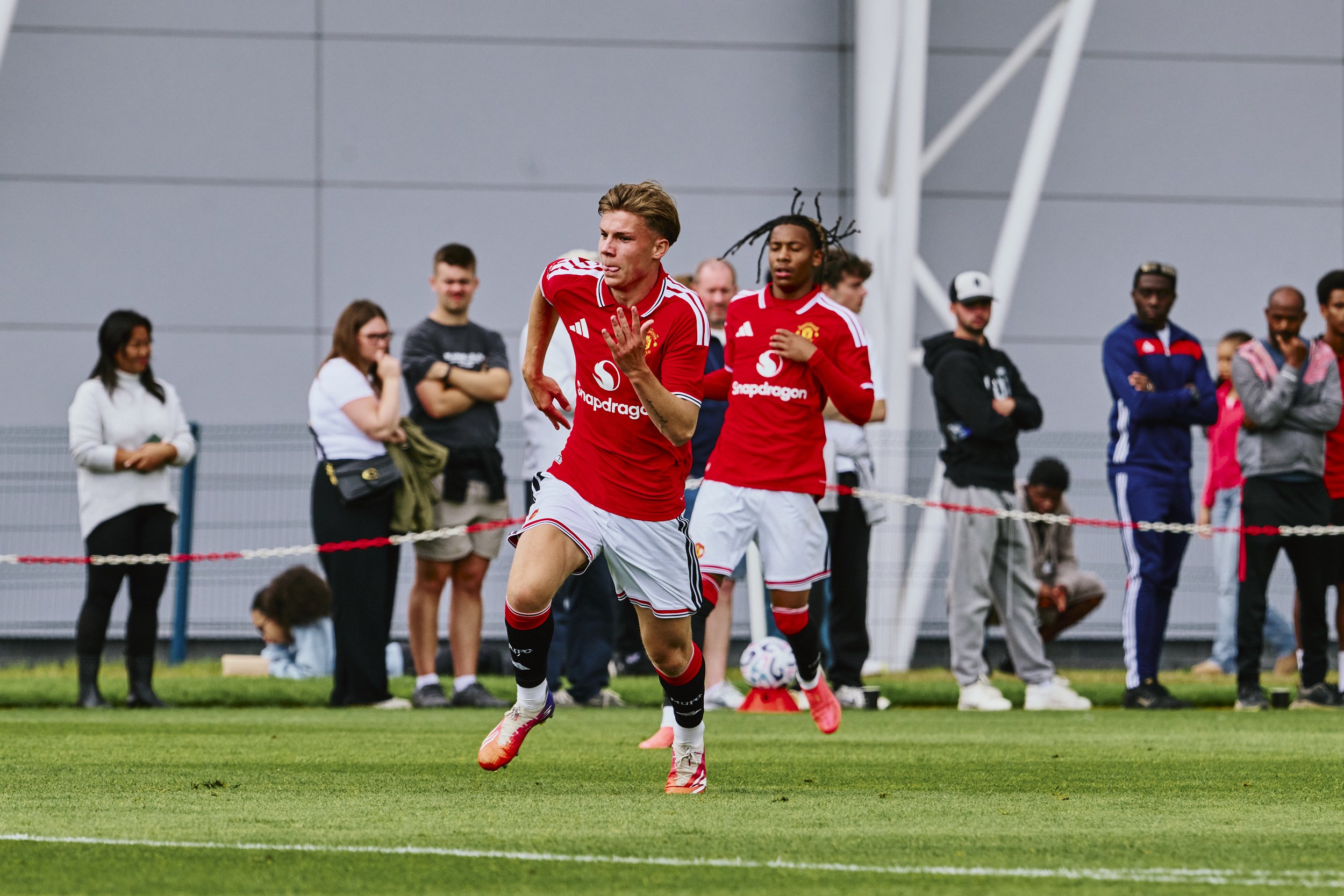 Louie Bradbury in action v Manchester City at Carrington