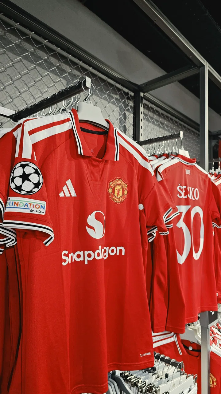 Image of Champions League badge on shirt in Old Trafford Megastore