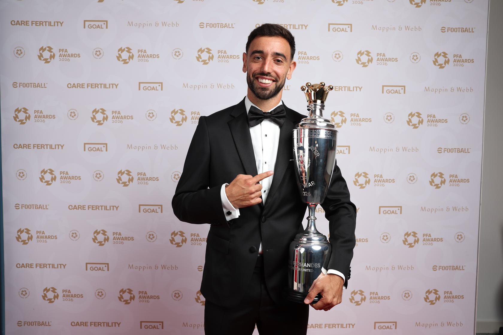 Bruno Fernandes points at Player of the Year trophy on red carpet