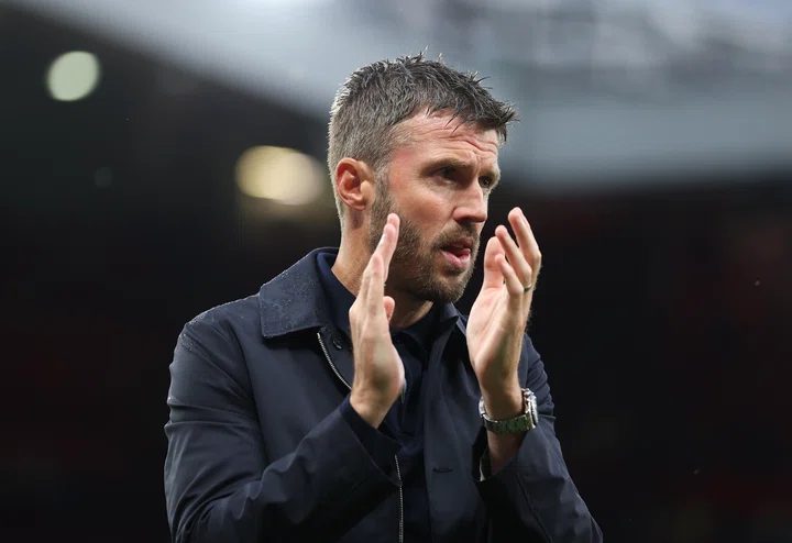 Michael Carrick wet hair applauds fans after Ipswich win