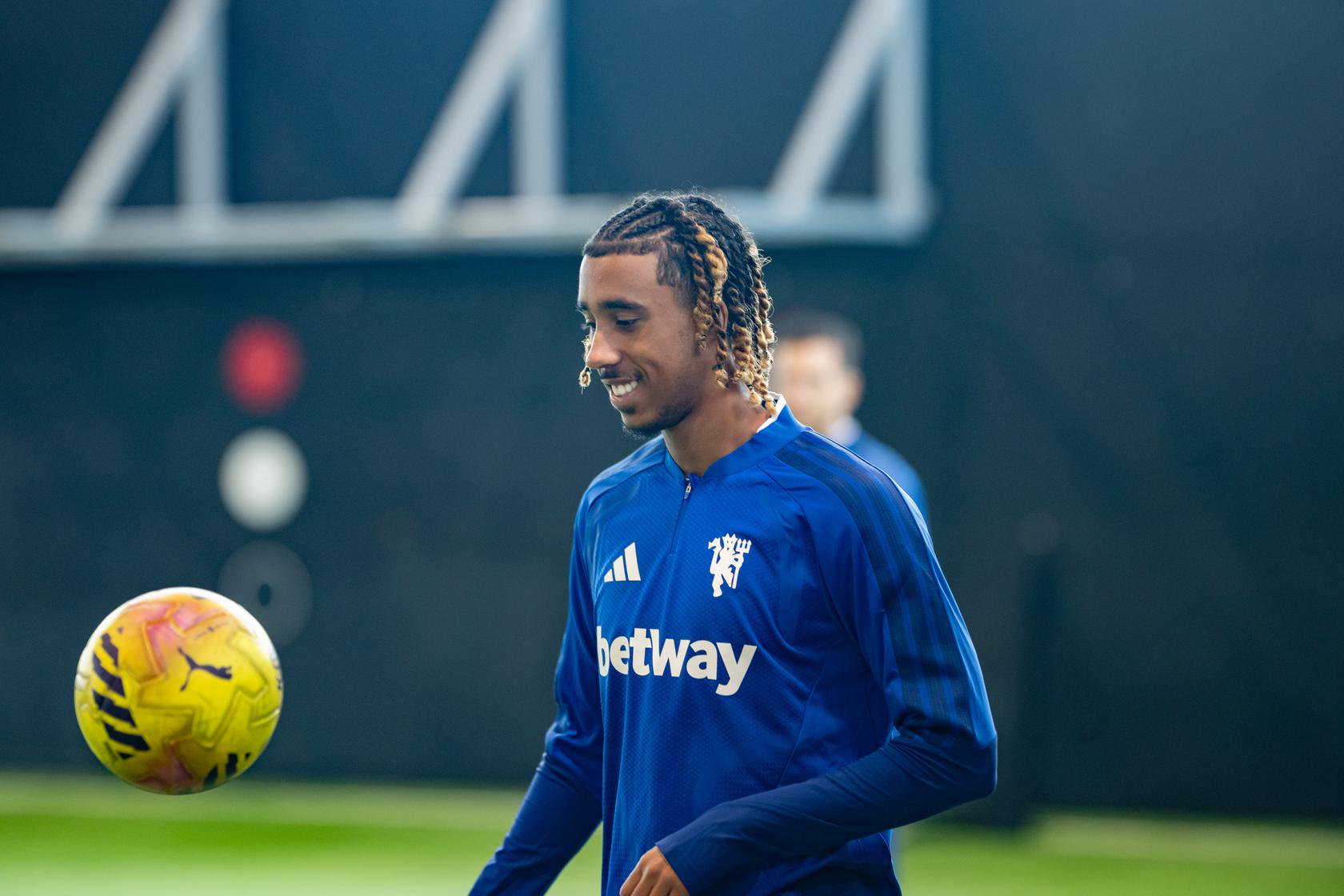 Leny Yoro smiling with the ball