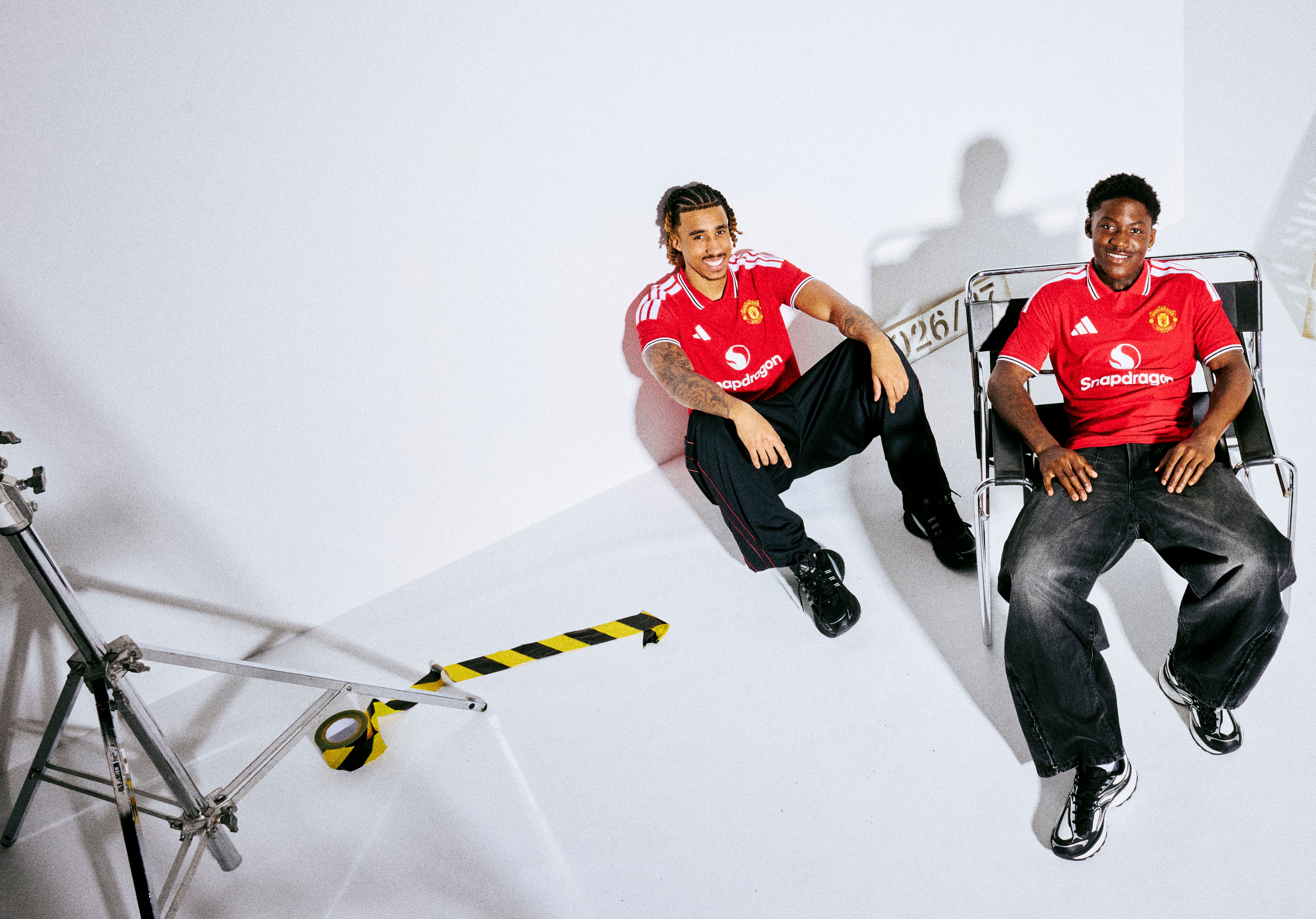 Leny Yoro and Kobbie Mainoo sat at 26/27 home kit shoot