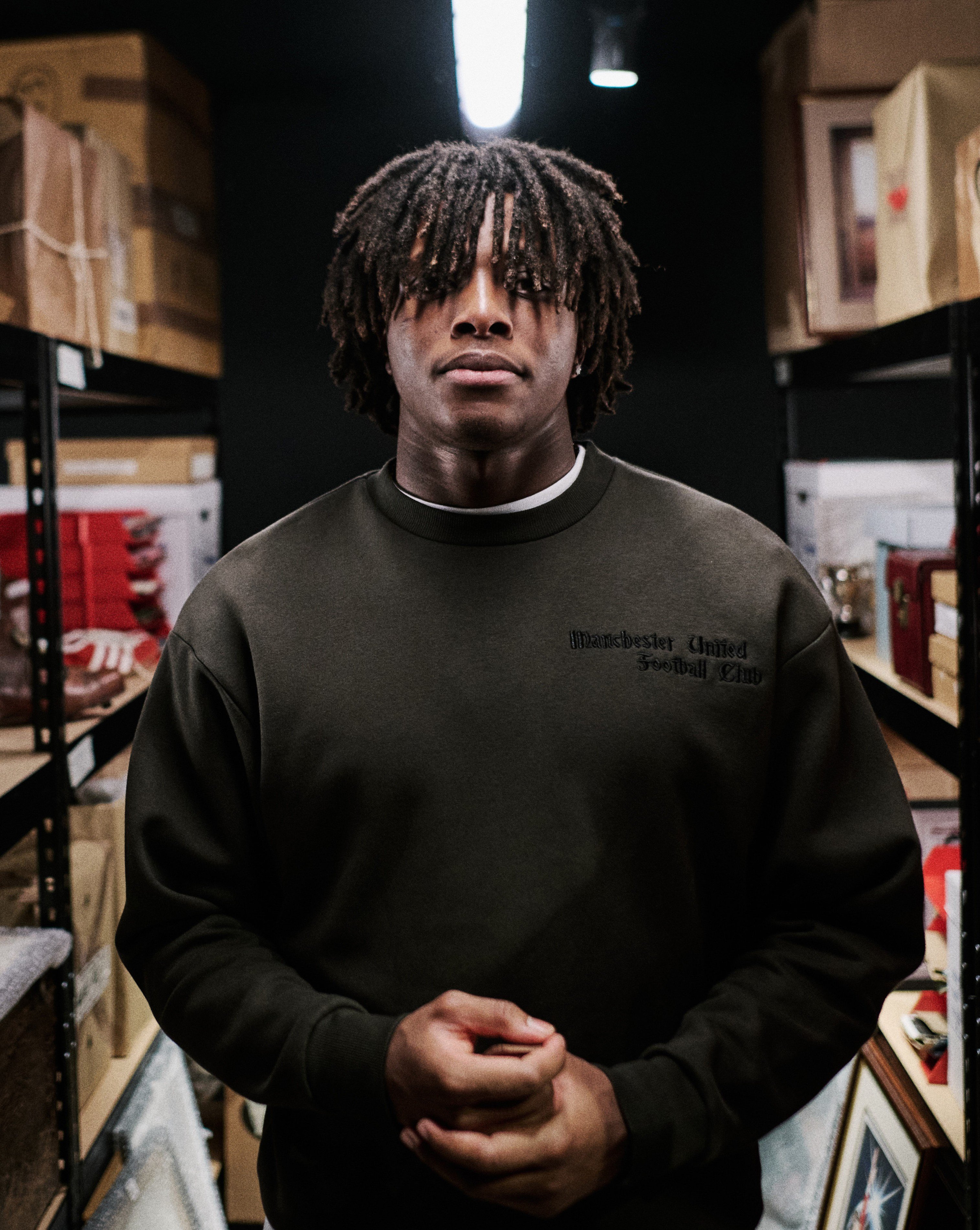 Patrick Chinazaekpere Dorgu surrounded by historic items