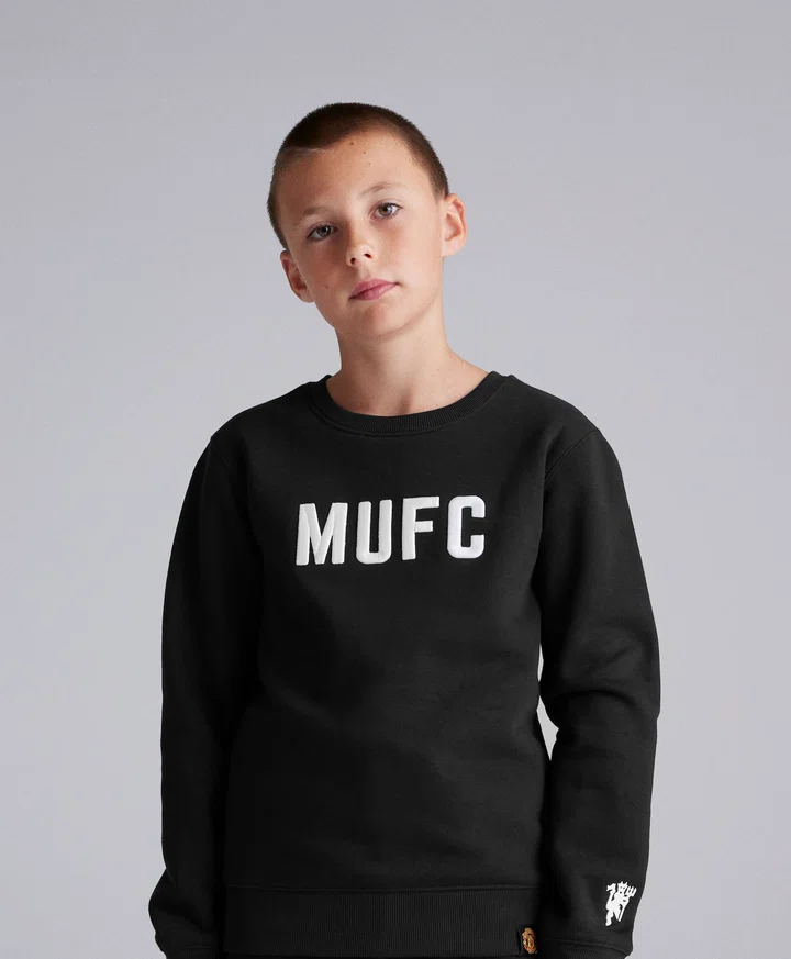 Young fan in black MUFC jumper at photoshoot