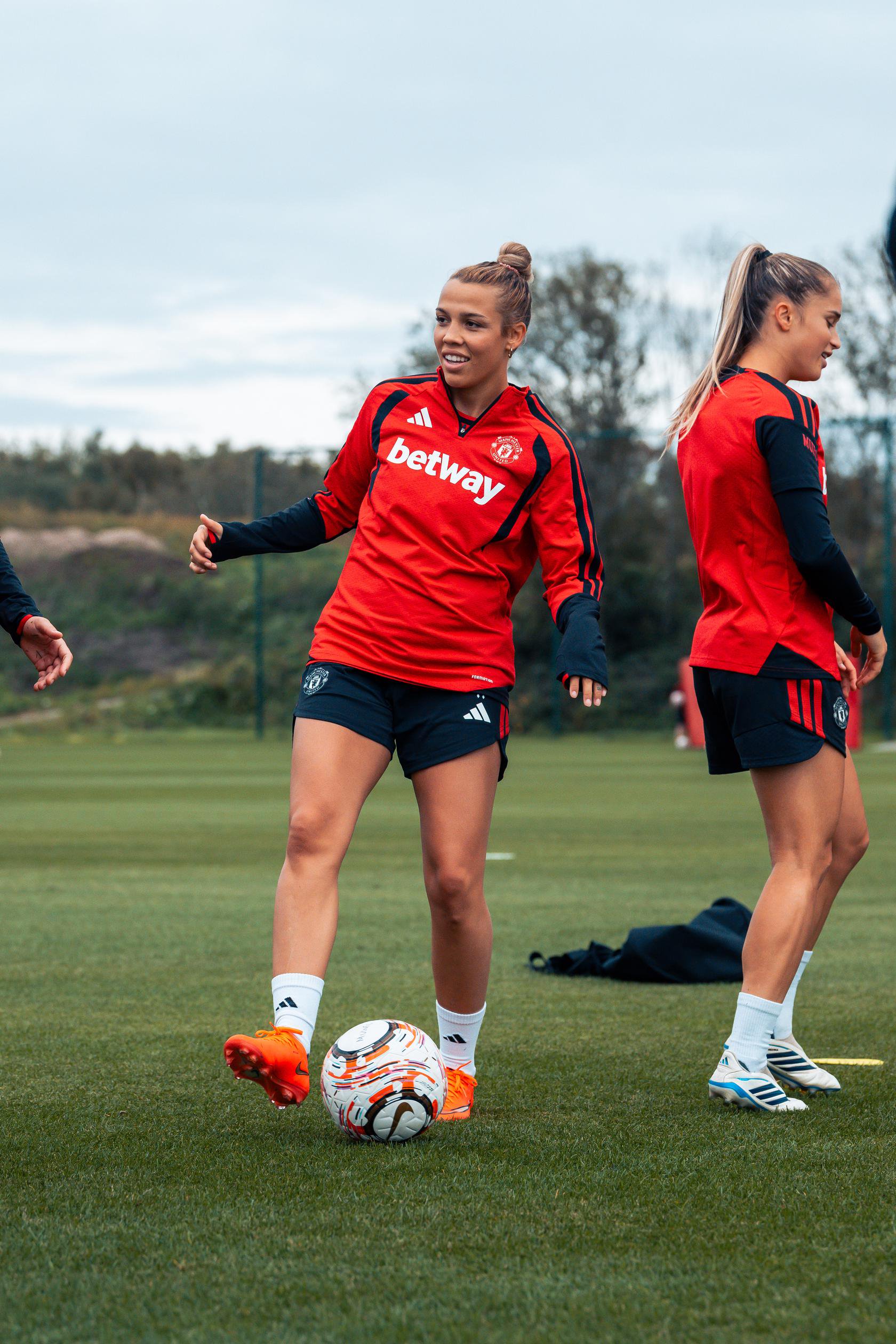 Celin Bizet Donnum smiling while kicking ball in training