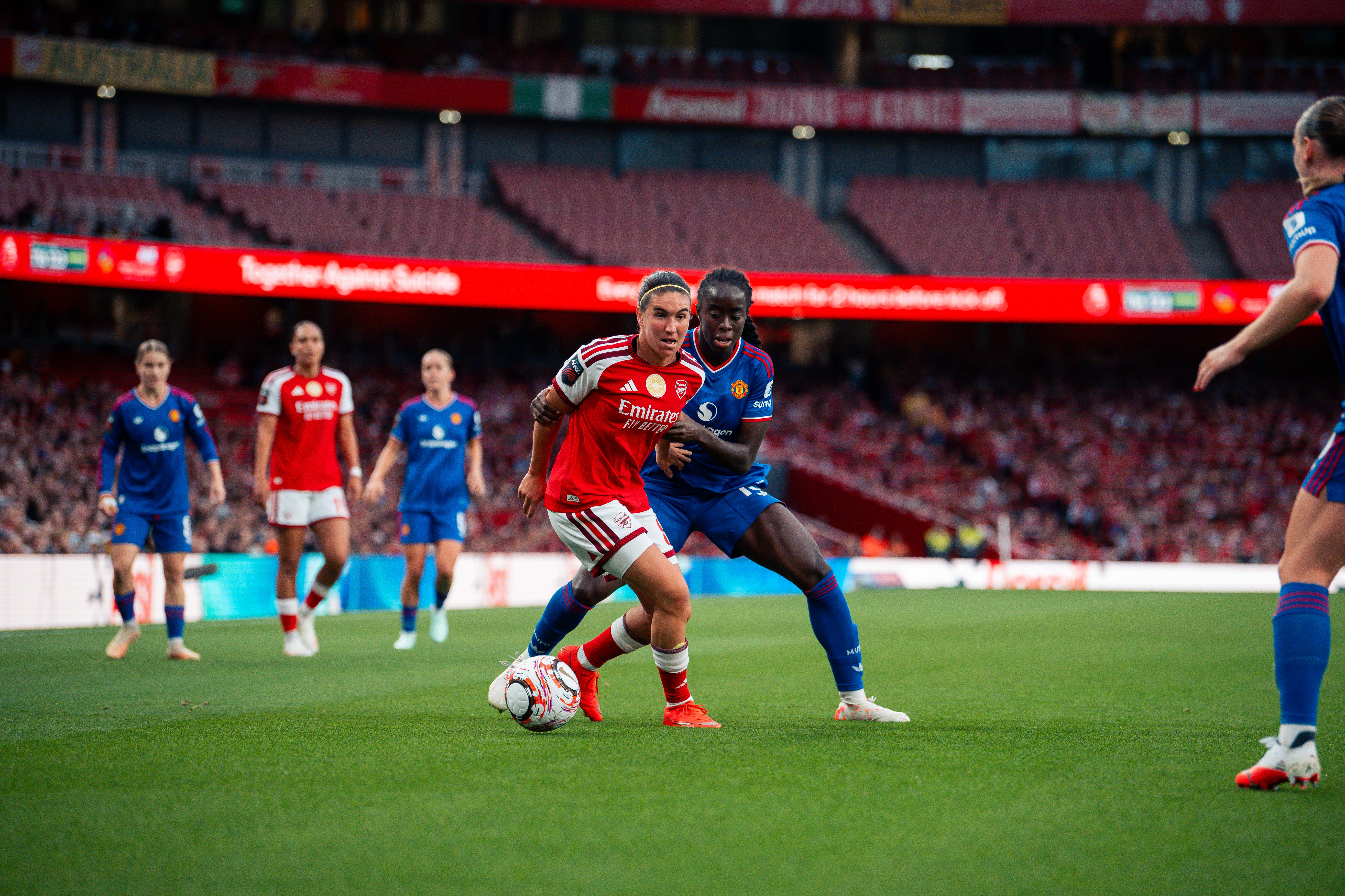 Simi Awujo battles for possession against Arsenal
