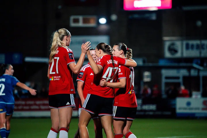 Layla Drury and Jess Anderson celebrate with Elisabeth Terland after goal at Durham