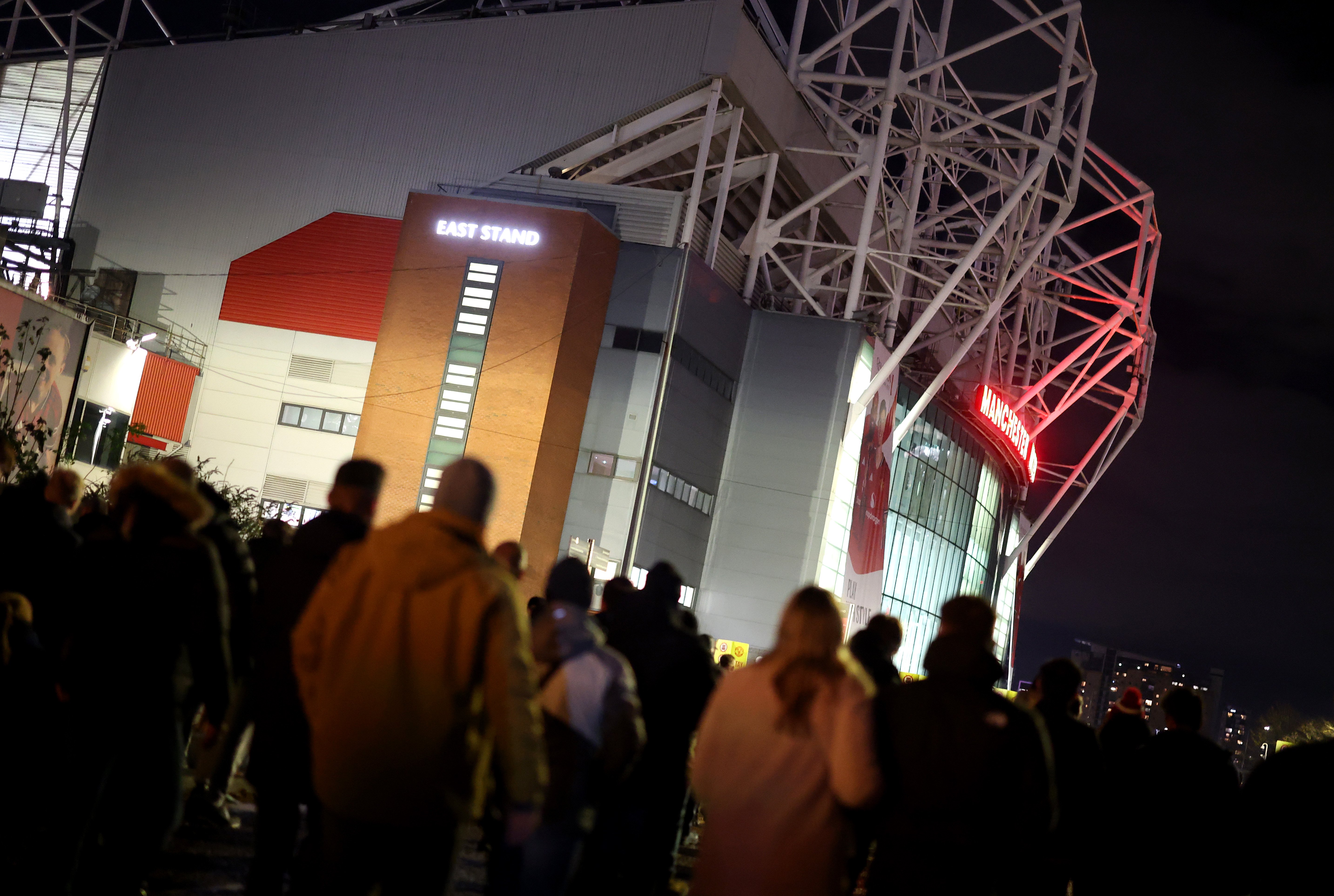 Image of fans walking to Old Trafford for a night game
