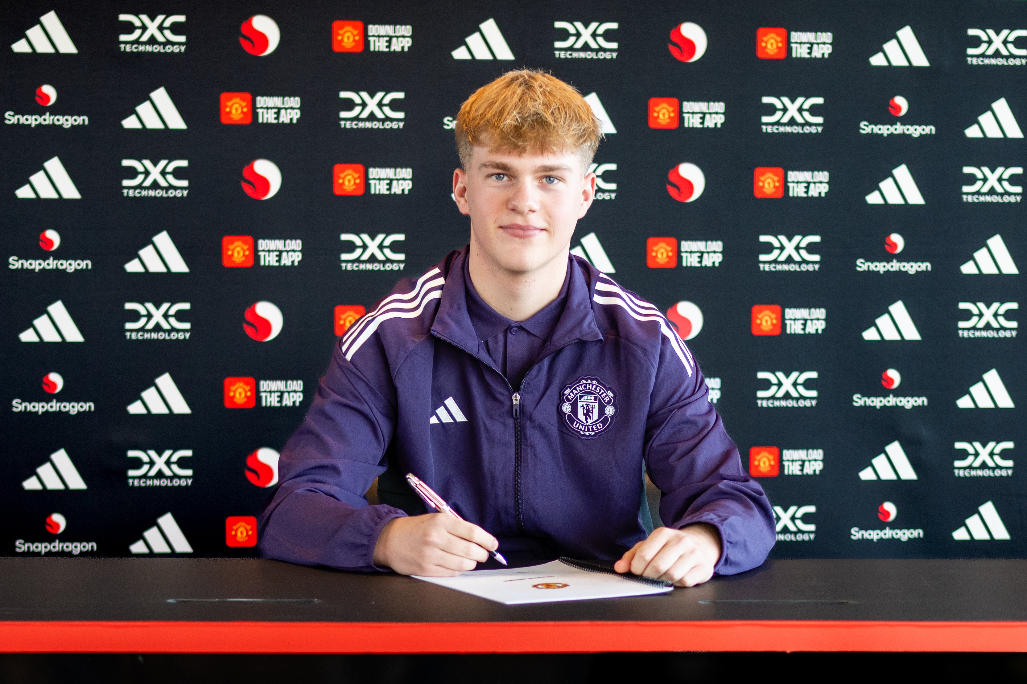 Charlie Hardy signing contract at United